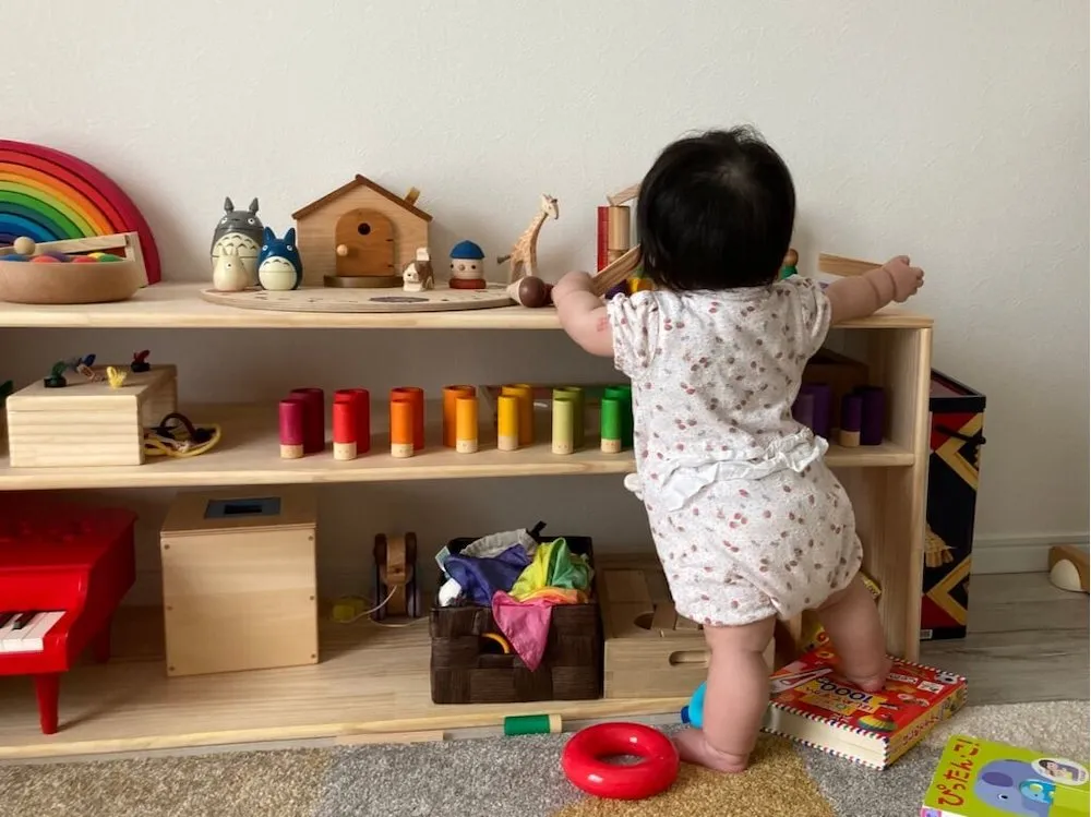 おもちゃ棚の天板で遊ぶ娘